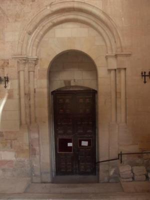 Fotografía de la Puerta del Mercado románica de la catedral, en la actualidad. Se halla situada al final de una escalera descendente, presentando evidencias de reconstrucción en su lateral derecho.