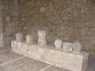 Conjunto de estelas discoideas, situadas sobre un murete tras la restauración del pórtico de la iglesia
