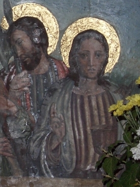 San Juan Evangelista retratado en la predela del retablo