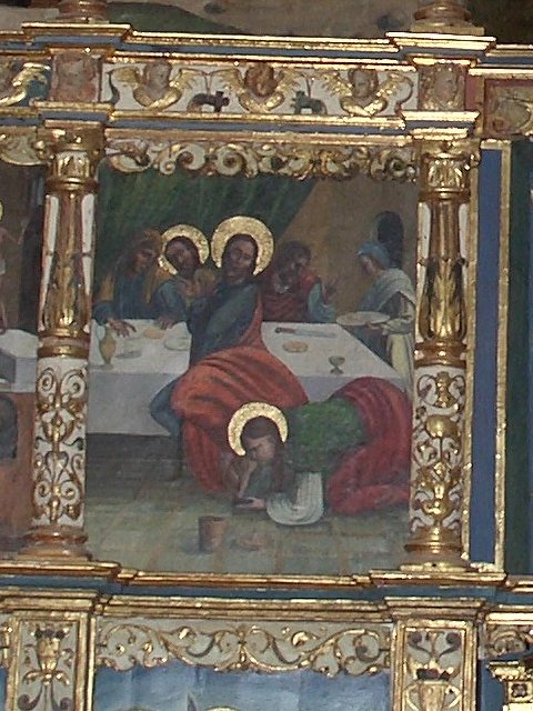 Escena donde una mujer con orla de santidad unge los pies de Jesús hallándose este comiendo en casa de Simón el Fariseo